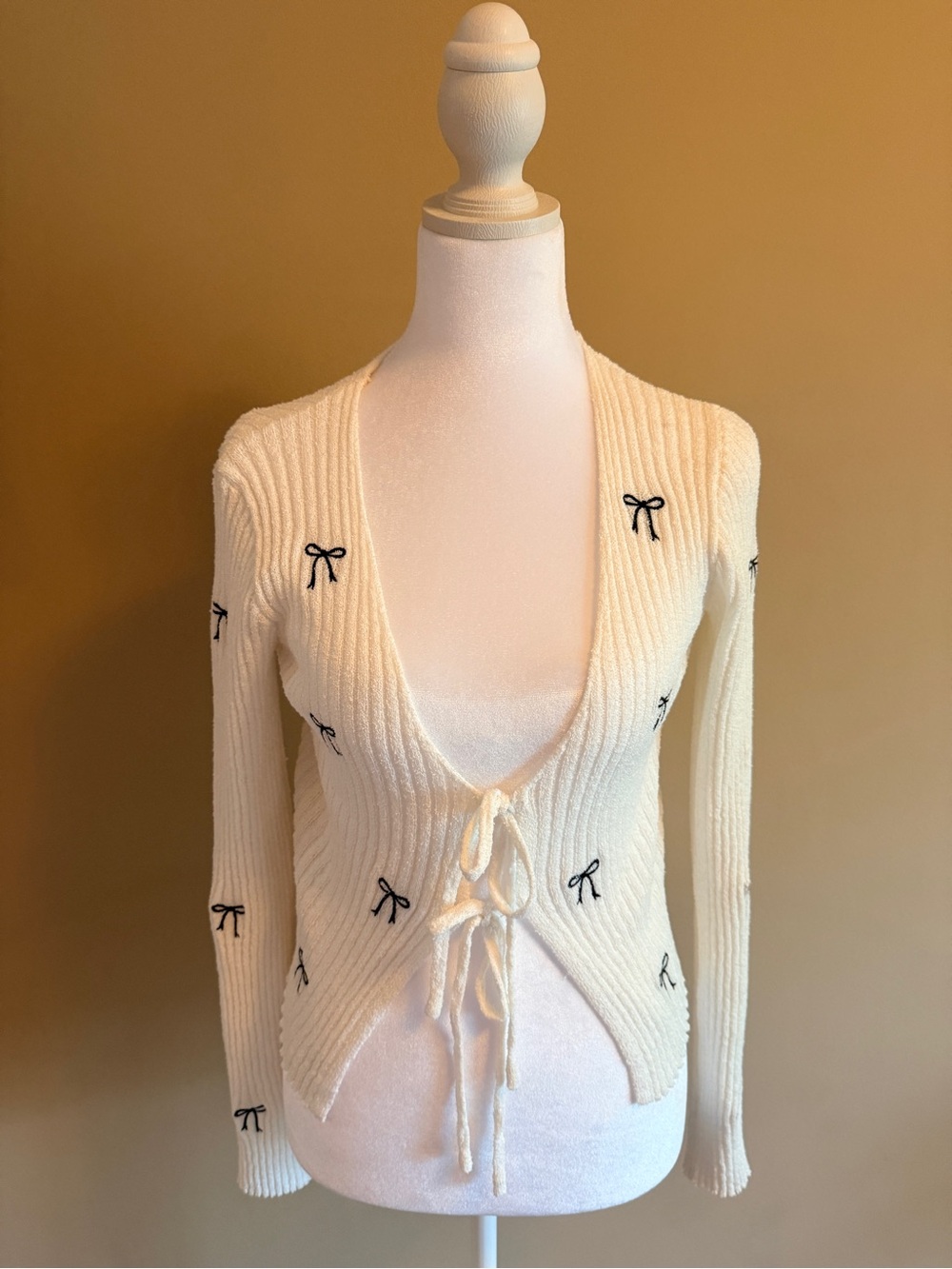 Altar'd State Cream Ribbed Tie-Front Cardigan with Black Bow Accents